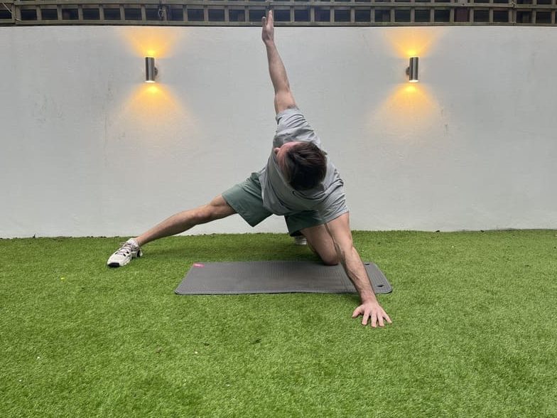 man demonstrates adductor rockback stretch