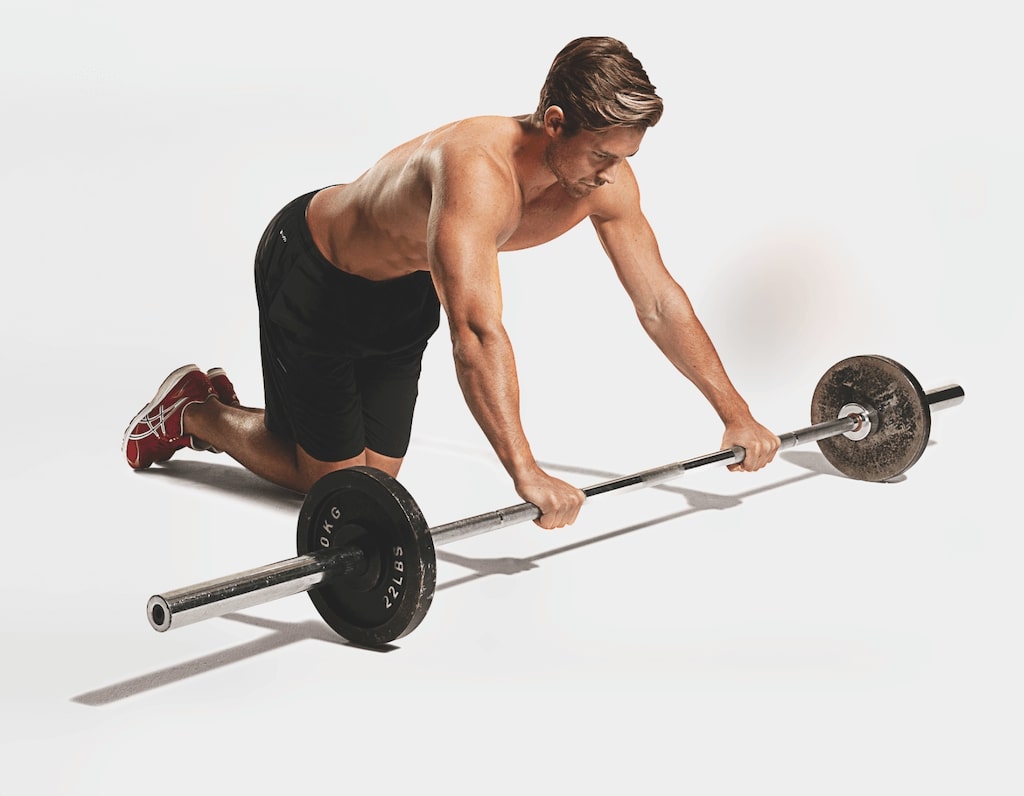 man demonstrating barbell rollout best abs exercises