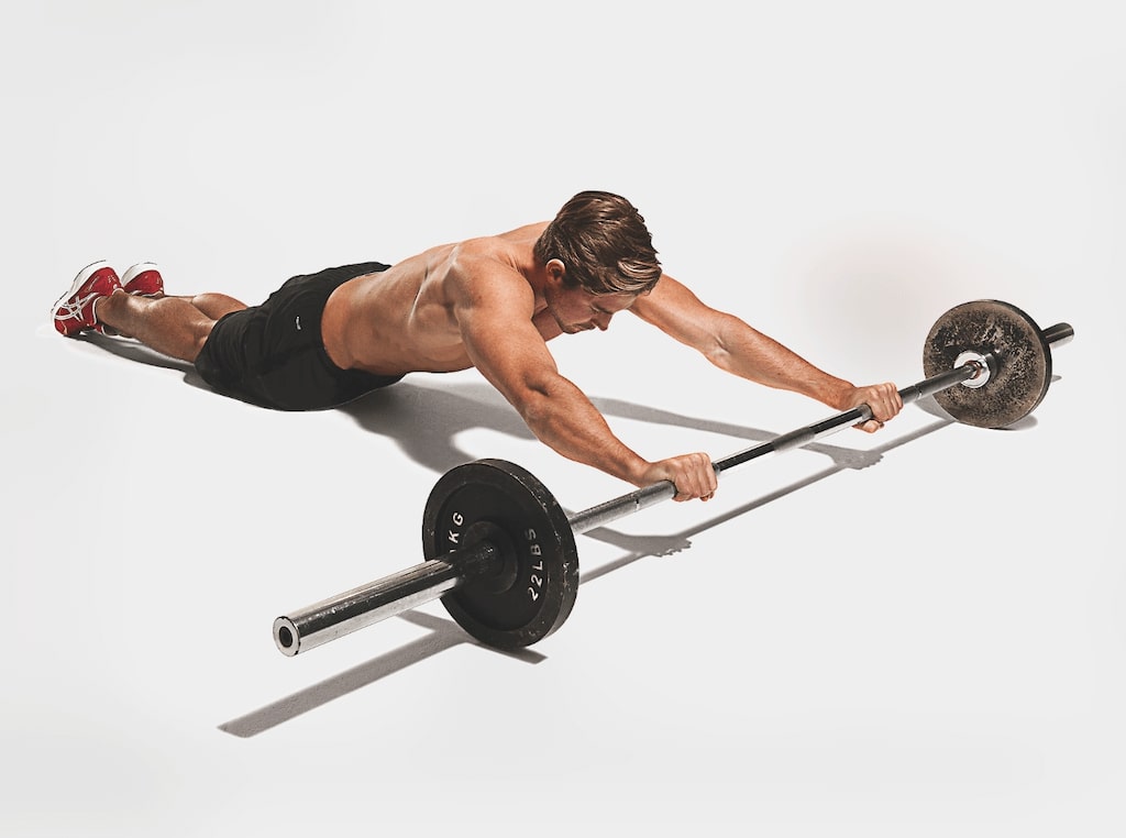man demonstrating barbell rollout best abs exercises