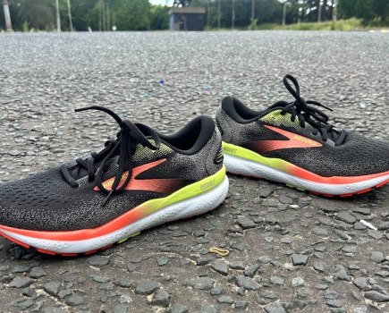 A pair of Brooks shoes on tarmac