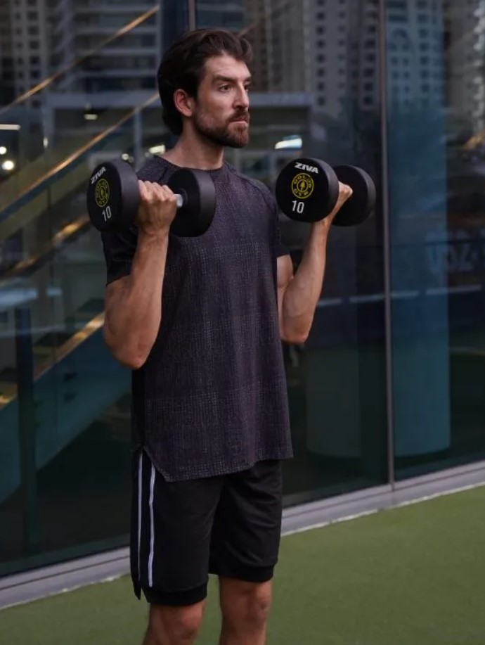 Man performing dumbbell 21s 