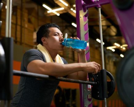 Man drinking water in the gym