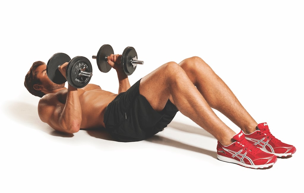 man demonstrating dumbbell crunch best abs exercises