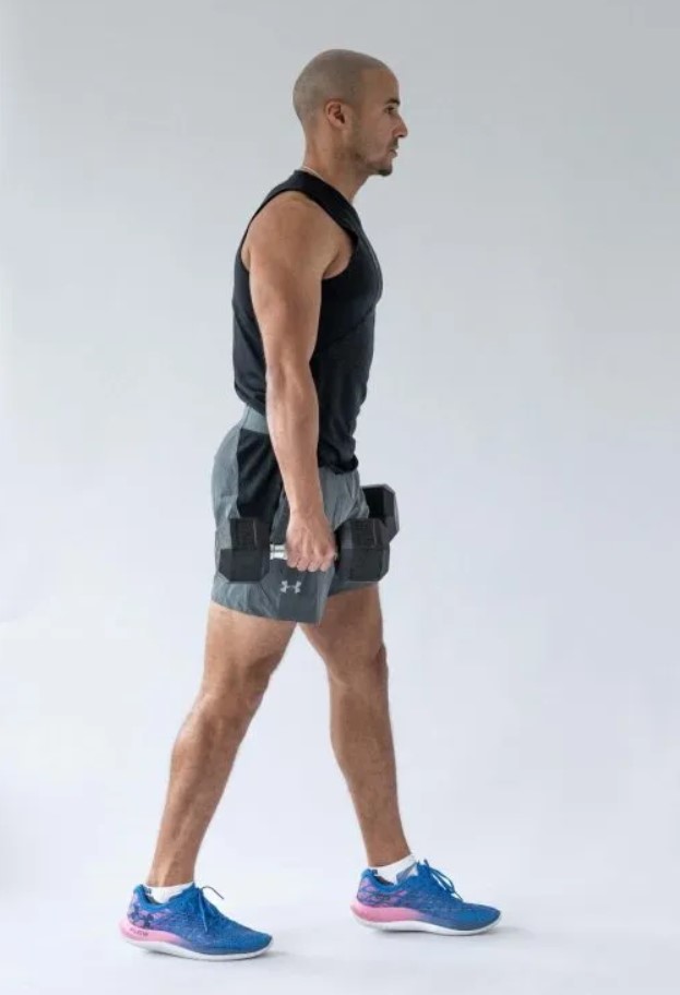 Man performing a dumbbell famer's walk