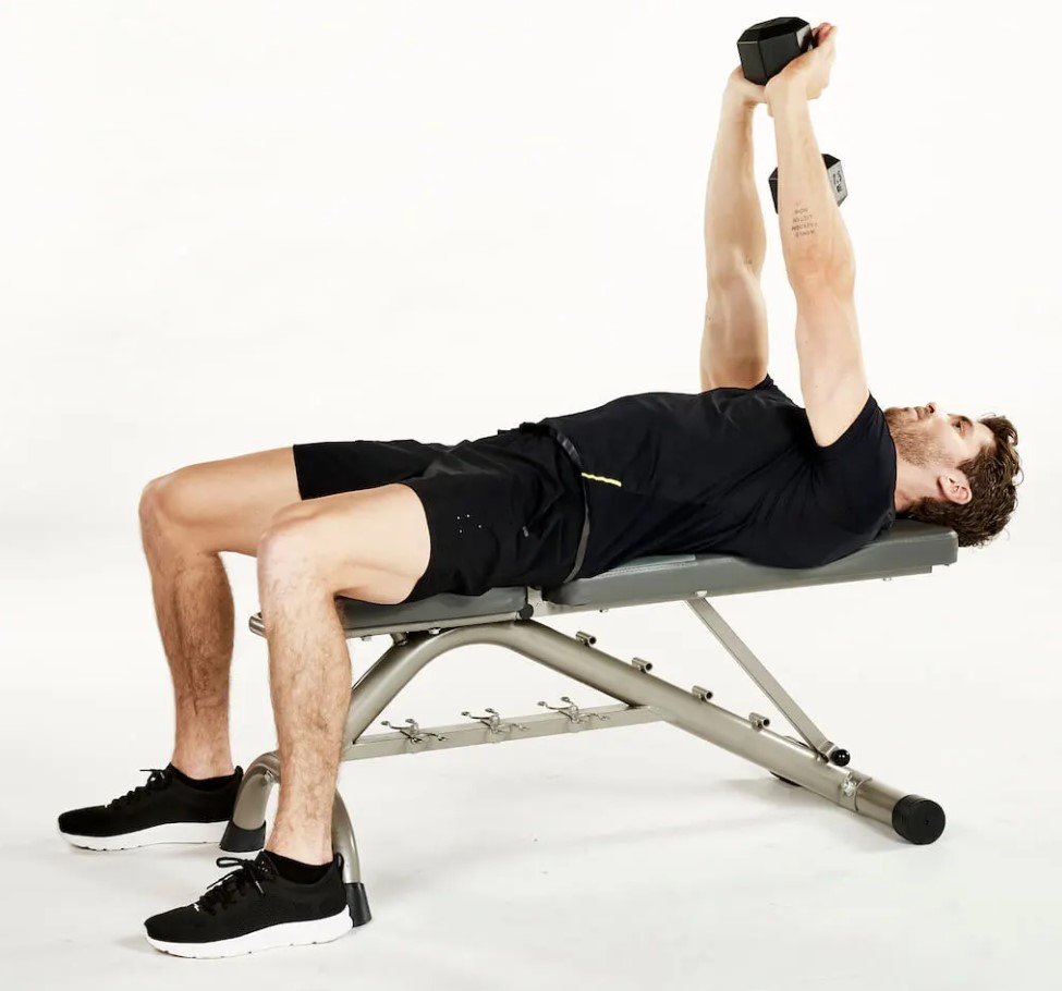 Man performing dumbbell pull-over