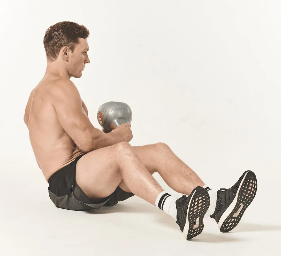 Man performing a kettlebell Russian twist