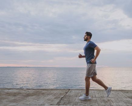 Man cooling down after running by the sea
