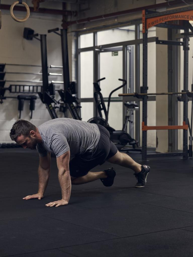 man demonstrates mountain climbers, one of the best bodyweight exercises for core strength