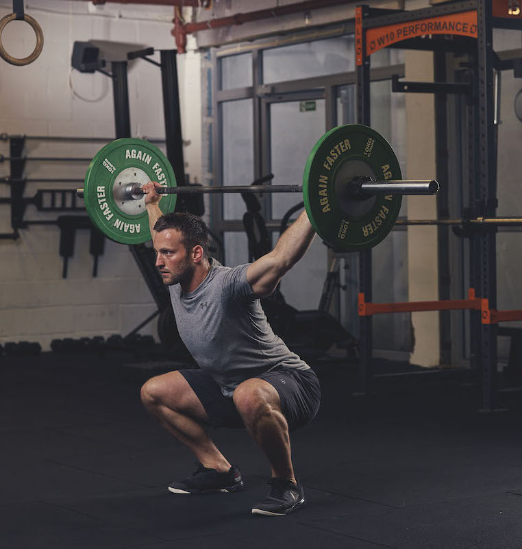 Man demonstrating a Barbell Overhead Squat