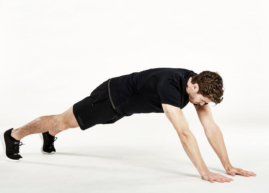 Man performing an extended plank exercise