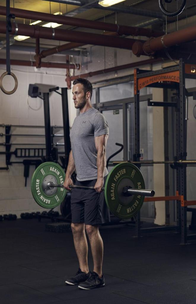 man demonstrating romanian deadlift in full body gym workout