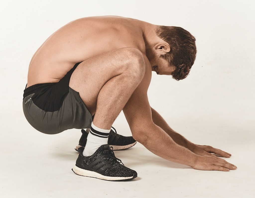 man demonstrates the caveman stretch