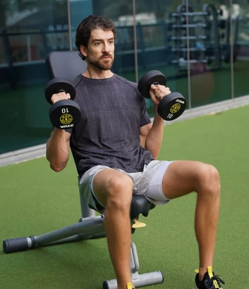 Man performing a seated dumbbell hammer curl