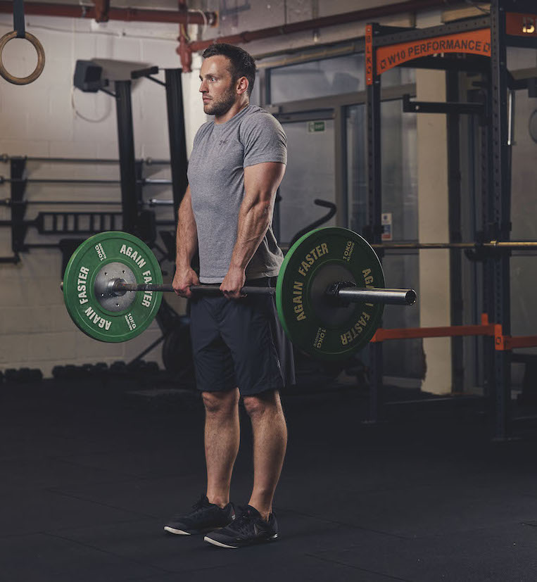 Man demonstrating a Barbell Shrug