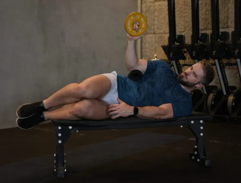 Man on a bench performing a side-lying external rotation exercise