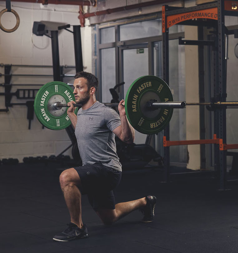 Man demonstrating a Barbell Split Squat 