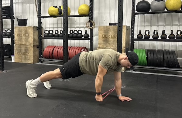 man in gym performing banded abs exercise