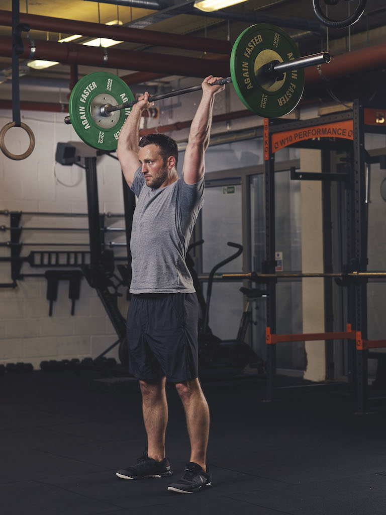 Man demonstrating a Barbell Thruster